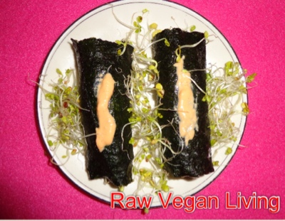 nori rolls with drizzled with cheese and sprouts
